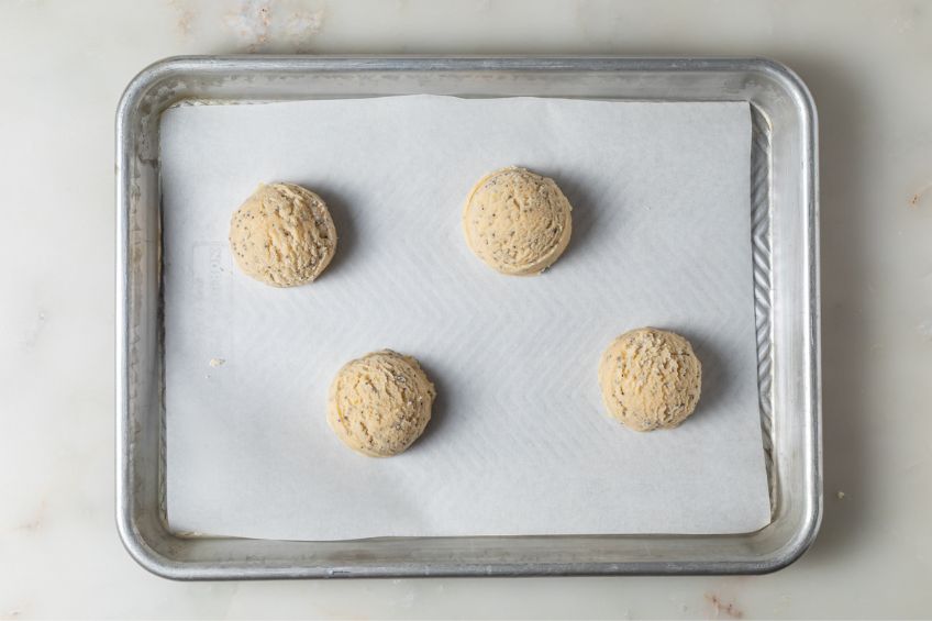 Cookie dough scooped into balls on cookie sheet