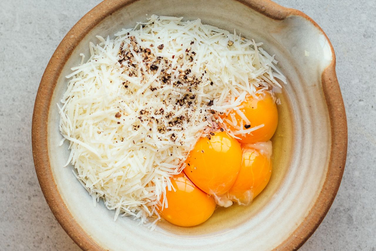 Carbonara Ramen ingredients in a mixing bowl