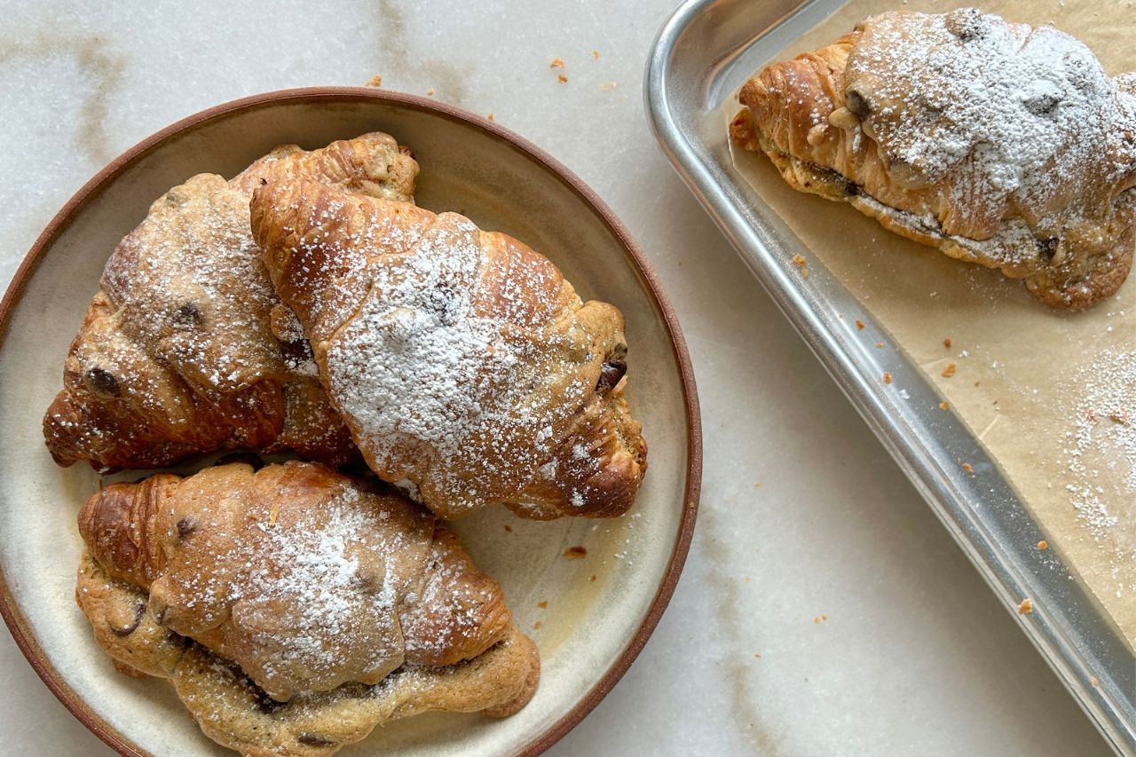 chocolate chip cookie-filled croissant final image dusted in icing sugar