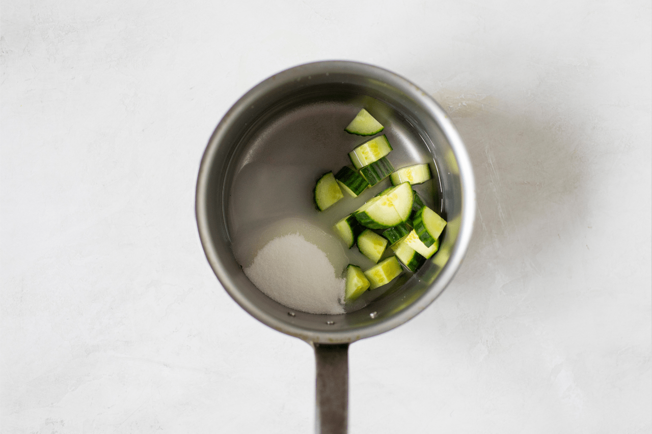 Cucumber and sugar in a saucepan