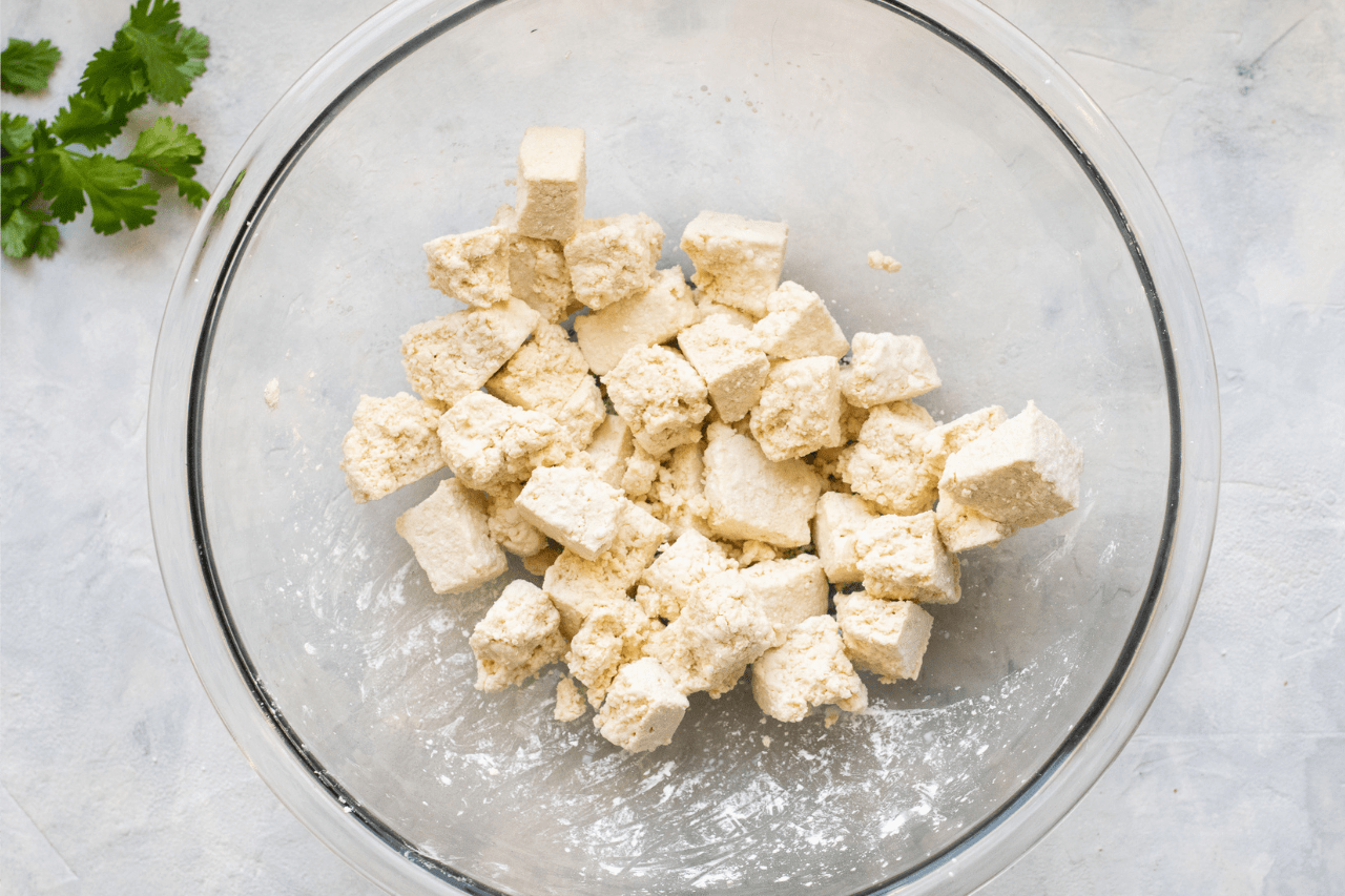 Tofu coated in corn starch in a bowl