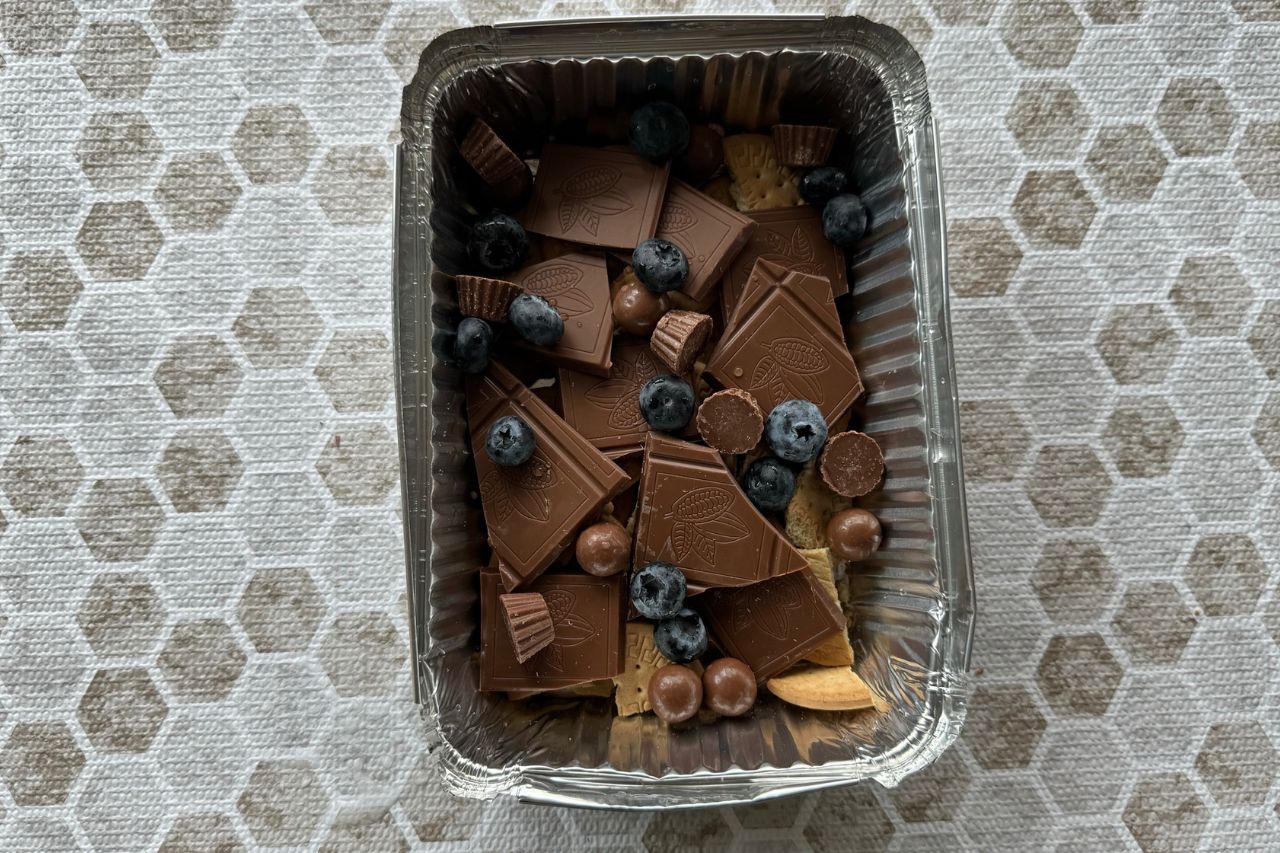 Chocolate and biscuits for the oven baked s'mores in a tin tray