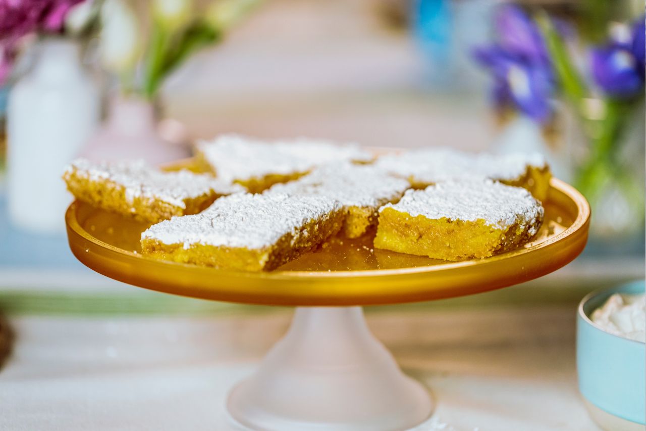 Ree Drummond's pineapple bars on a pedestal plate