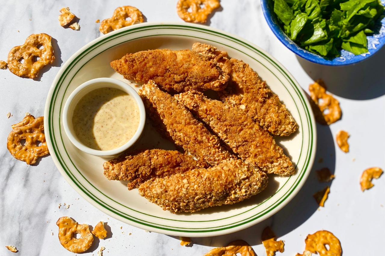 Pretzel-crusted chicken tenders on a plate