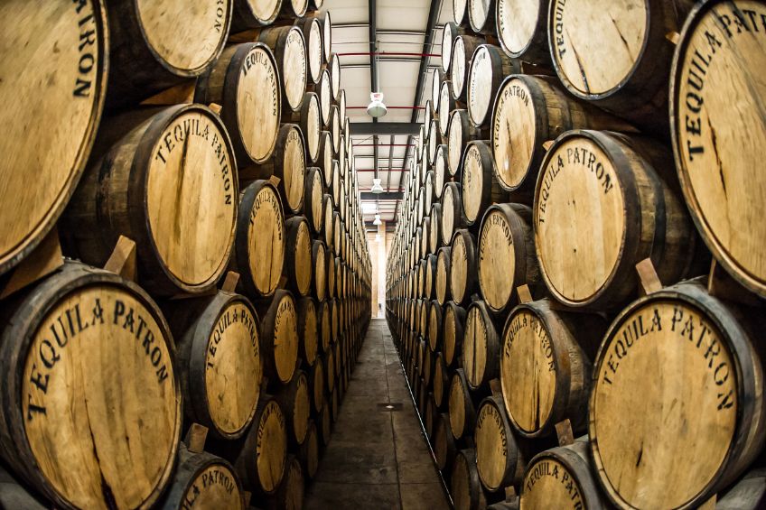 Two walls of Patron tequila barrels