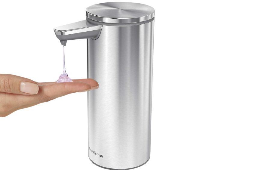 A hand using the Simplehuman Rechargeable Sensor Soap Dispenser