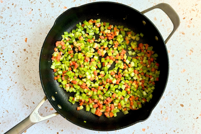 Carrots, celery and aromatics aadded to pan