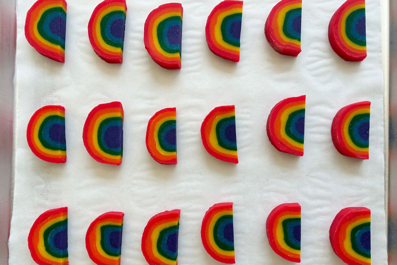 Cut up rainbow cookies on a baking tray