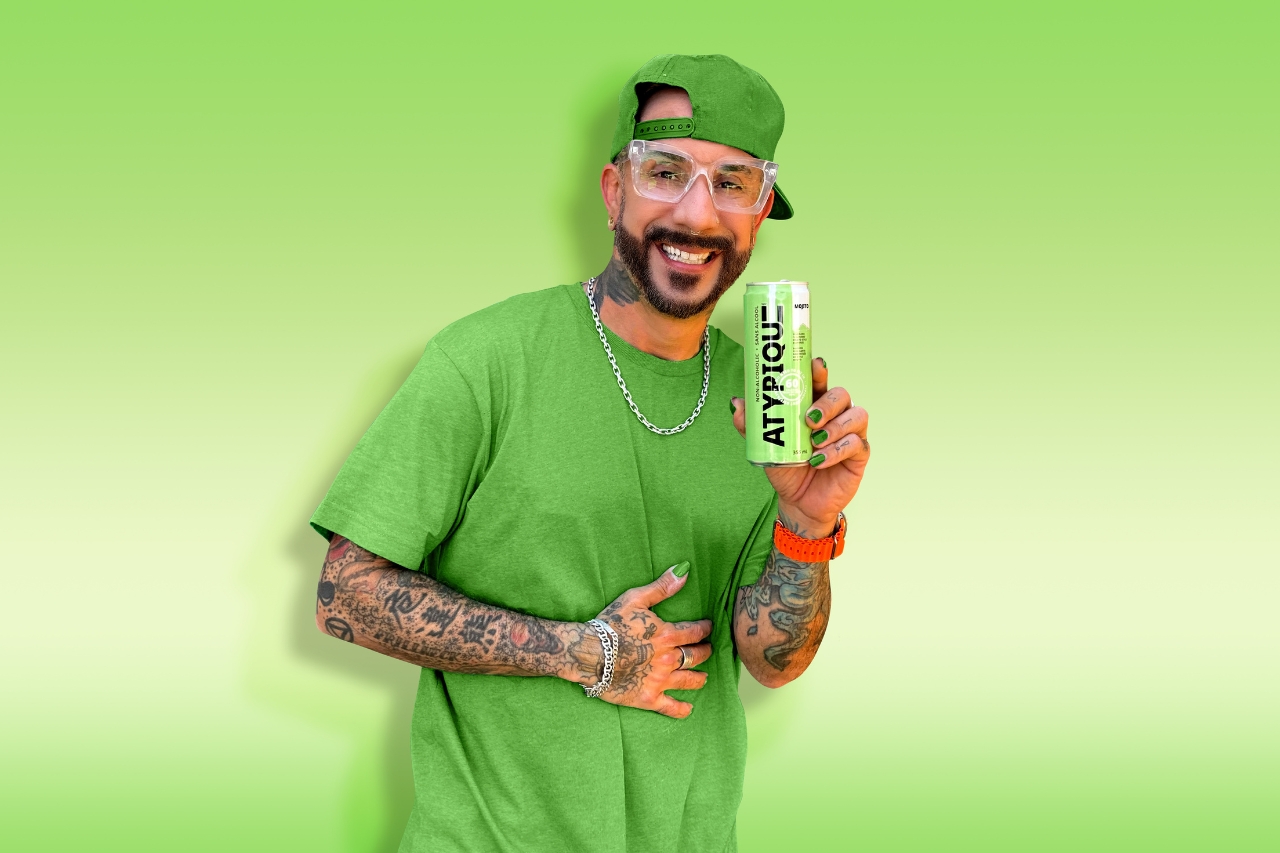 AJ McLean holding a can of Atypique