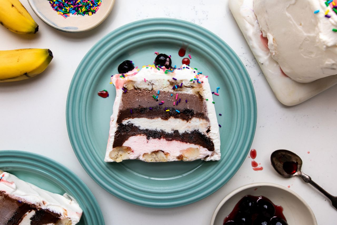 no bake banana split ice cream cake final image with sprinkles and cherries