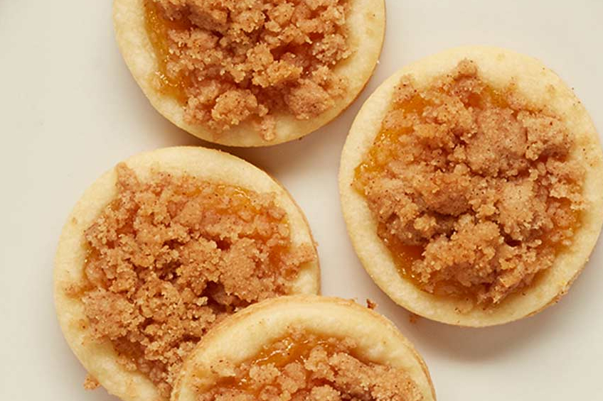 Four sugar cookies with apple pie filling and brown sugar topping