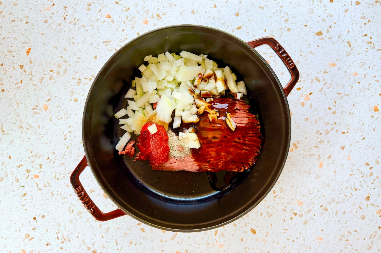 Ground beef, onions and seasonings in Dutch oven