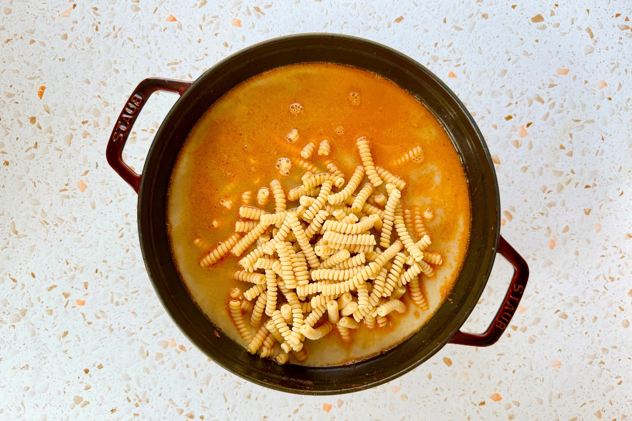 Beef broth, milk and pasta added to pot