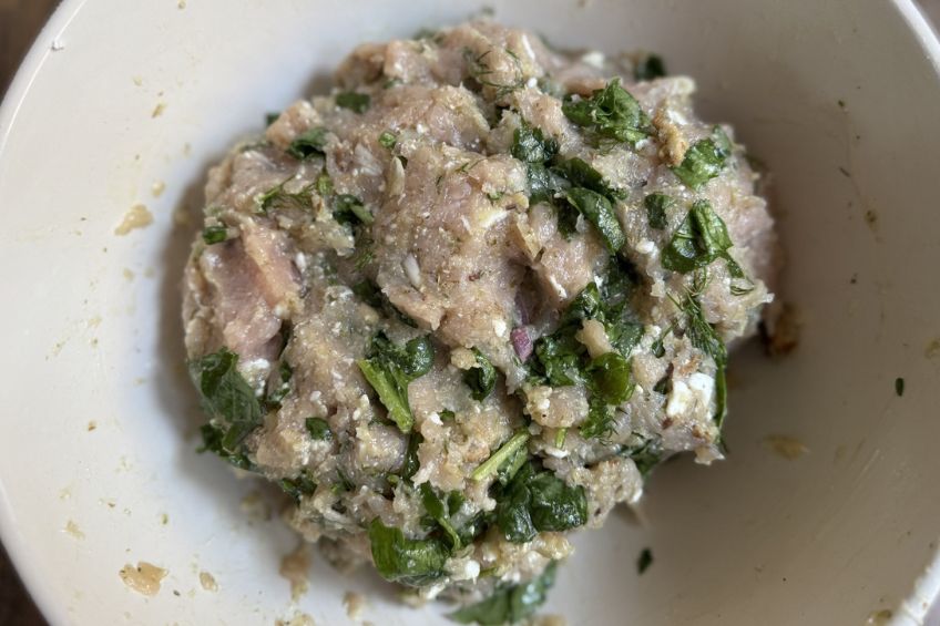 turkey meatballs with spinach and feta in a mixing bowl